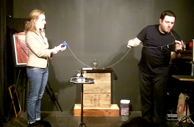 Mike Paldino performs his signature piece, Needle Swallowing, with a spectator in Philadelphia.