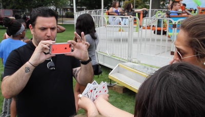 Mike Paldino performs a card trick using an iPhone at Seton Hall University, South Orange, NJ.