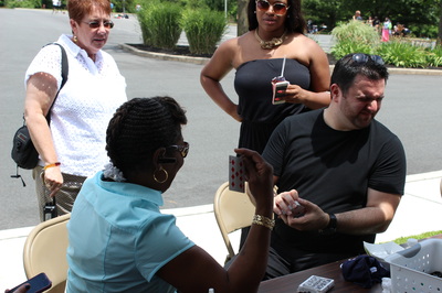 Mike Paldino performs card magic for a spectator, Ewing, NJ.