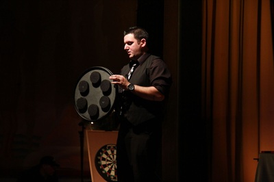 Magician Mike Paldino with Russian Roulette wheel and dart board in Boyertown, Pa.