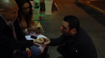 Mike Paldino bends a coin with a couple on the street in New York City.