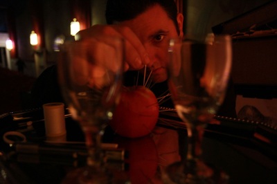 Magician Mike Paldino with needles, thread, and wine glasses, in Boyertown, Pa.