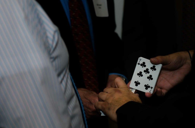 Mike Paldino performs sleight of hand for a spectator at the 14th Annual For The Public Good Fundraiser in Fort Lauderdale, Fl.